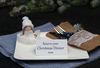 Christmas menu reservation: Set table with plates, cutlery, Christmas decorations and a place card...