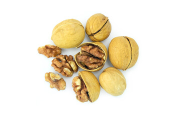 walnuts and nutcracker, Close up of roasted walnuts or Juglans regia  isolated on white background with clipping path top view flat lay stack, hard yellow shell and crunchy brown pulp