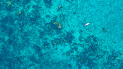 Aerial view of a kayak in the blue sea .man kayaking he does water sports activities.	