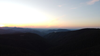 Sunset Over Mountain Range and Forest – Aerial View Landscape
