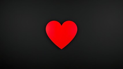 A striking red heart on a textured black background, representing deep emotions and minimalist beauty.