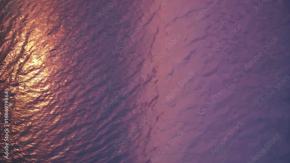 Poster the ocean surface glows with sunlight reflecting on the ocean as waves create patterns. ocean waves 