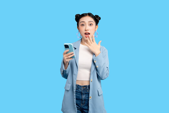 Asian Young businesswoman holds her phone and reacts with shock