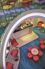 Fototapeta premium Single and mingle lounge bar snack bistro for solo travellers onboard modern cruiseship cruise ship liner in colorful futuristic interior design