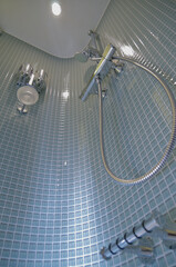 Modern design bathroom with sink, shower, towels and mirror and mosaic tiles in cabin or stateroom...
