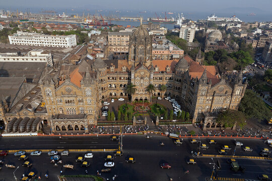 Aerial view of the historic Chhatrapati Shivaji Maharaj Terminus with its majestic dome and bustling streets below, Mumbai, Maharashtra, India.