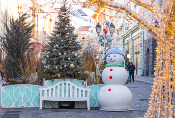 Concept of preparation and decoration for the New Year 2026. Holiday snowmen on the streets of...