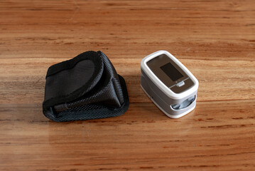 Pulse oxymeter with case on a table