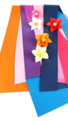 Colorful paper strips with origami flowers