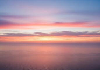 Obraz premium Colorful sunset over the sea with a calm horizon and beautiful sky view