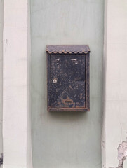 old metal mailbox hanging on the wall of the house, copy space