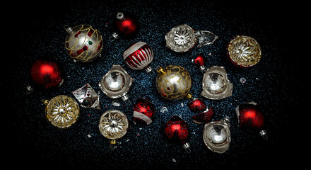 Vintage Christmas ornaments in red and gold on dark background  