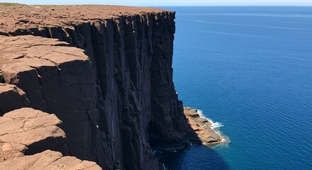 Coastal cliff face rugged rock formation ocean view natural landscape dark stone texture summer sunlight high vertical