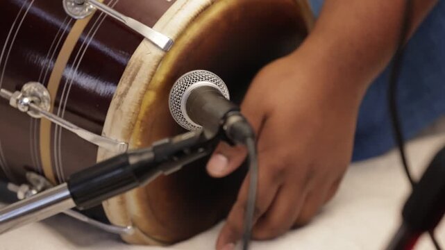 Closeup shot of hands of a man playing dholak