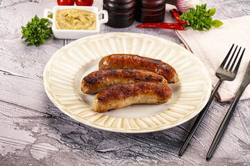 Delicous natural roasted sausages in the plate