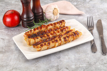 Grilled meat sausages wrapped bacon
