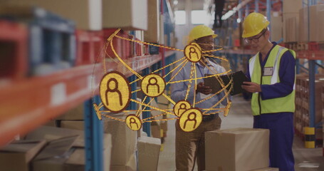 Warehouse workers wearing hardhats, vests checking boxes on tablet in warehouse aisle, with overlay