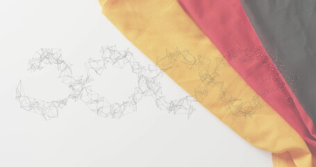 Displaying draped tricolor cloth flowing onto studio backdrop with network mesh shapes, copy space