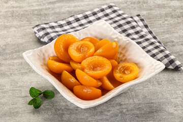 Sweet canned apricots with syrope