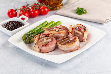 Tasty grilled pork medallion with bacon