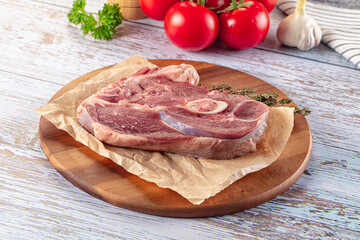 Raw lamb steak with bone