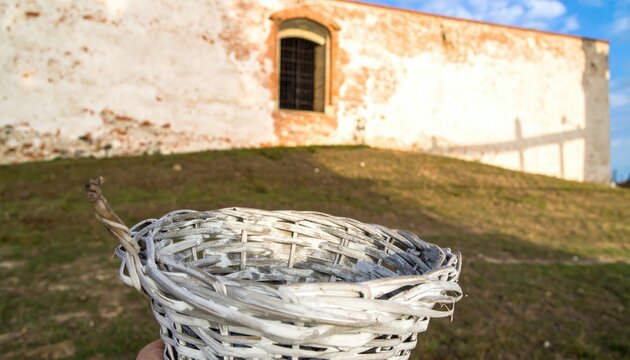 Whitewashed Basket Against Old Building Wall