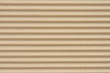 Obraz premium A full frame close-up shows a textured surface with horizontal parallel ridges and grooves in a beige tone