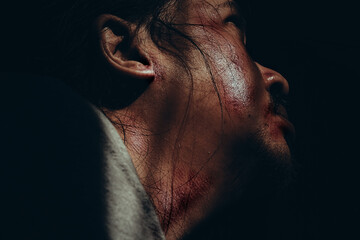 Close-Up of Scary Face with Wounds and Blood in Low Light