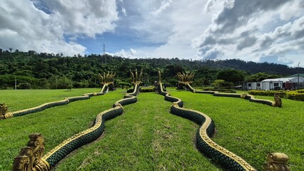 Green grass and giant snake statue