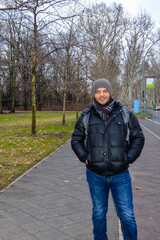 Man in winter clothing standing in Treptower Park, Berlin, Germany.