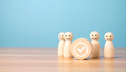 Wooden peg dolls standing on a wooden table with a wooden background.