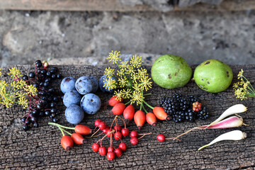 Still life of wild fruits placed on a wooden board