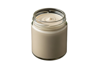 A clear glass jar filled with creamy, light beige sauce is featured against a stark black backdrop.