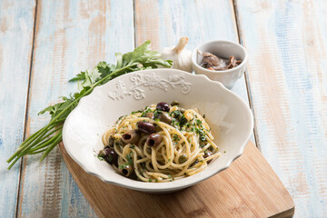 spaghetti with anchovy capers  black olives and parsley
