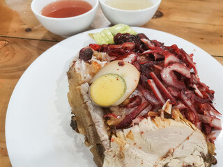 Appetizing char siu rice on plate showcasing flavors served with soup bowls