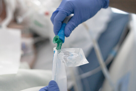 Doctor inflating cuff of endotracheal tube in hospital setting