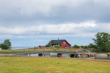 Obraz premium Scenic wooden cottage in Finland. Traditional Nordic architecture, cozy rural atmosphere, surrounded by nature, peaceful landscape, and northern charm