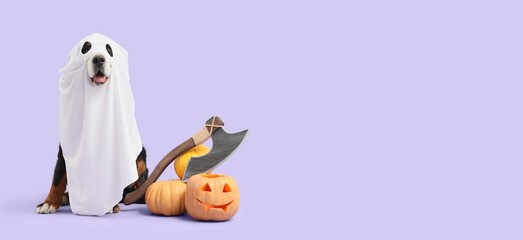 Dog dressed as ghost and Halloween decorations on lilac background with space for text