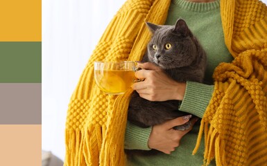 Young woman with warm plaid and cute cat drinking tea at home on autumn day, closeup. Different color patterns © Pixel-Shot