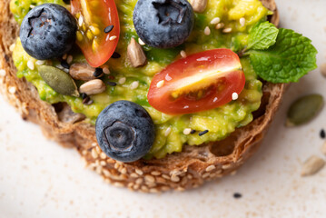 Avocado toast with blueberries, tomatoes, sunflower seed, pumpkin seed and sesame seed, Healthy eating