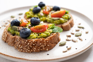 Avocado toast with blueberries, tomatoes, sunflower seed, pumpkin seed and sesame seed, Healthy eating
