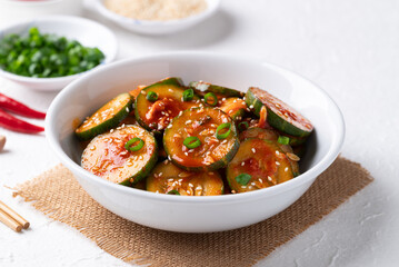 Korean cucumber salad (Oi muchim) in bowl on white background, Korean side dish