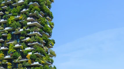 Fotobehang Milaan A stunning view of a green covered sustaineble building showcases innovative architecture blending nature and urban living under clear sky.  © 24K-Production