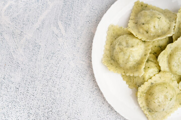Plate of tasty ravioli on white background
