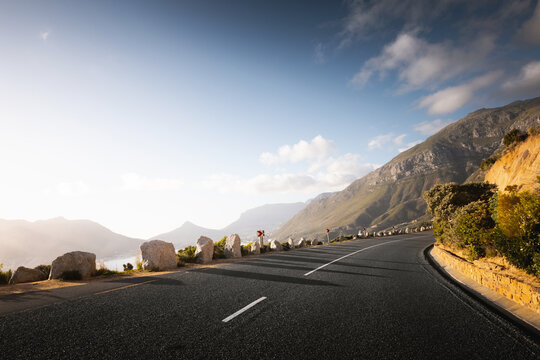 Scenic road along Ocean and Mountains at sunset. Chapman&rsquo;s Peak Drive.