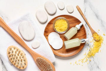 Composition with spa accessories and bottles of essential oil on light background