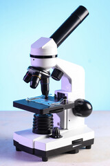 Modern microscope on white table