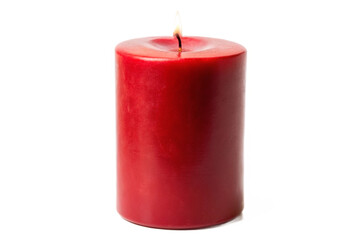 Isolated red pillar candle with a glowing flame centered against a pure black backdrop transparent background