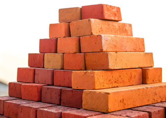 Obraz premium Stack of orange bricks arranged in a pyramid shape against a white background