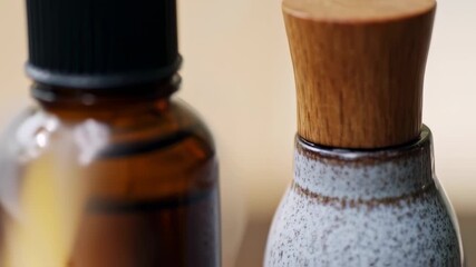 Soothing close-up of natural cosmetic bottles with a gentle, deliberate focus pull - Powered by Adobe